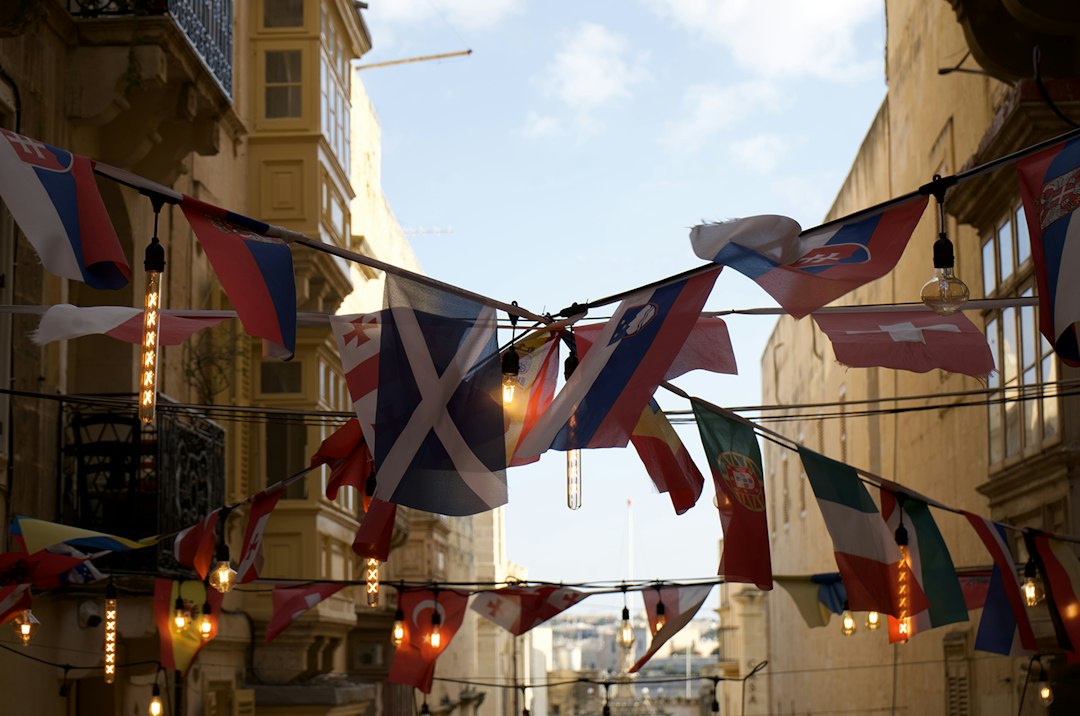 Historic street in Valletta with Maltese flags